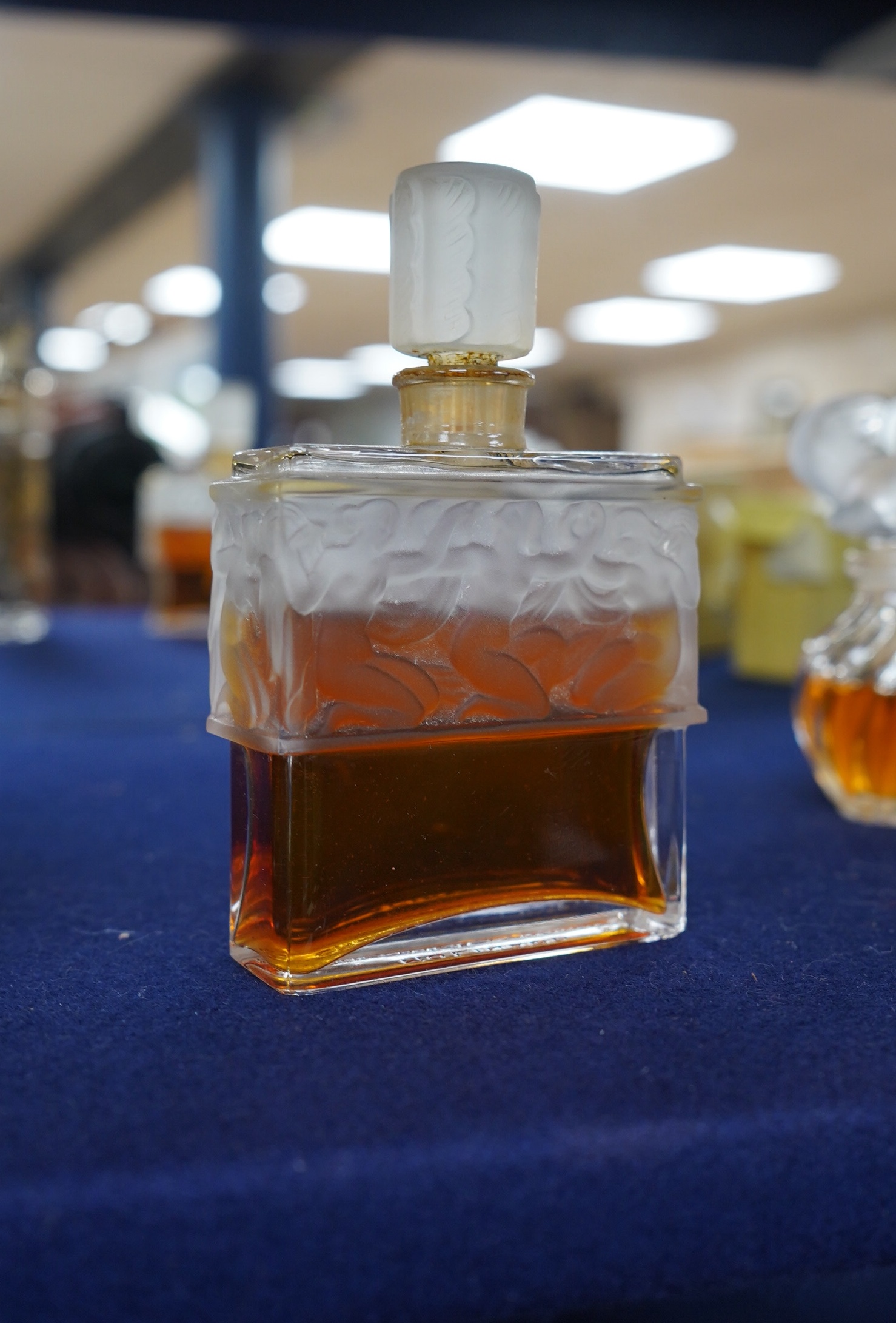 Three Lalique perfume bottles and atomisers, together with two others, tallest 14cm. Condition - fair.